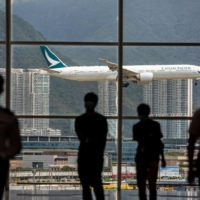 A Cathay Pacific aircraft comes in to land at Hong Kong International Airport earlier this month | AFP-JIJI