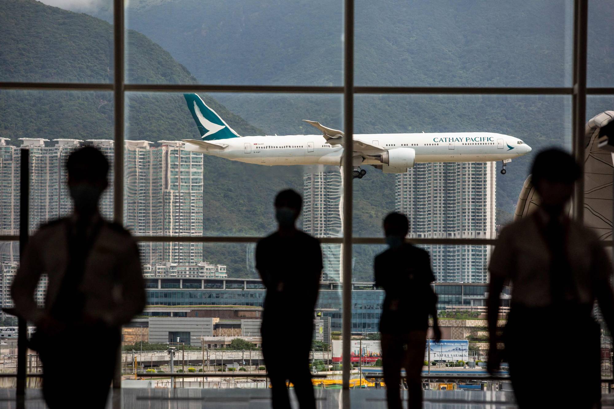 A Cathay Pacific aircraft comes in to land at Hong Kong International Airport earlier this month | AFP-JIJI