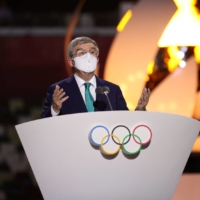 IOC President Thomas Bach delivers a speech next to Tokyo 2020 President Seiko Hashimoto during the closing ceremony of the Olympics on Aug. 8. | POOL / VIA REUTERS