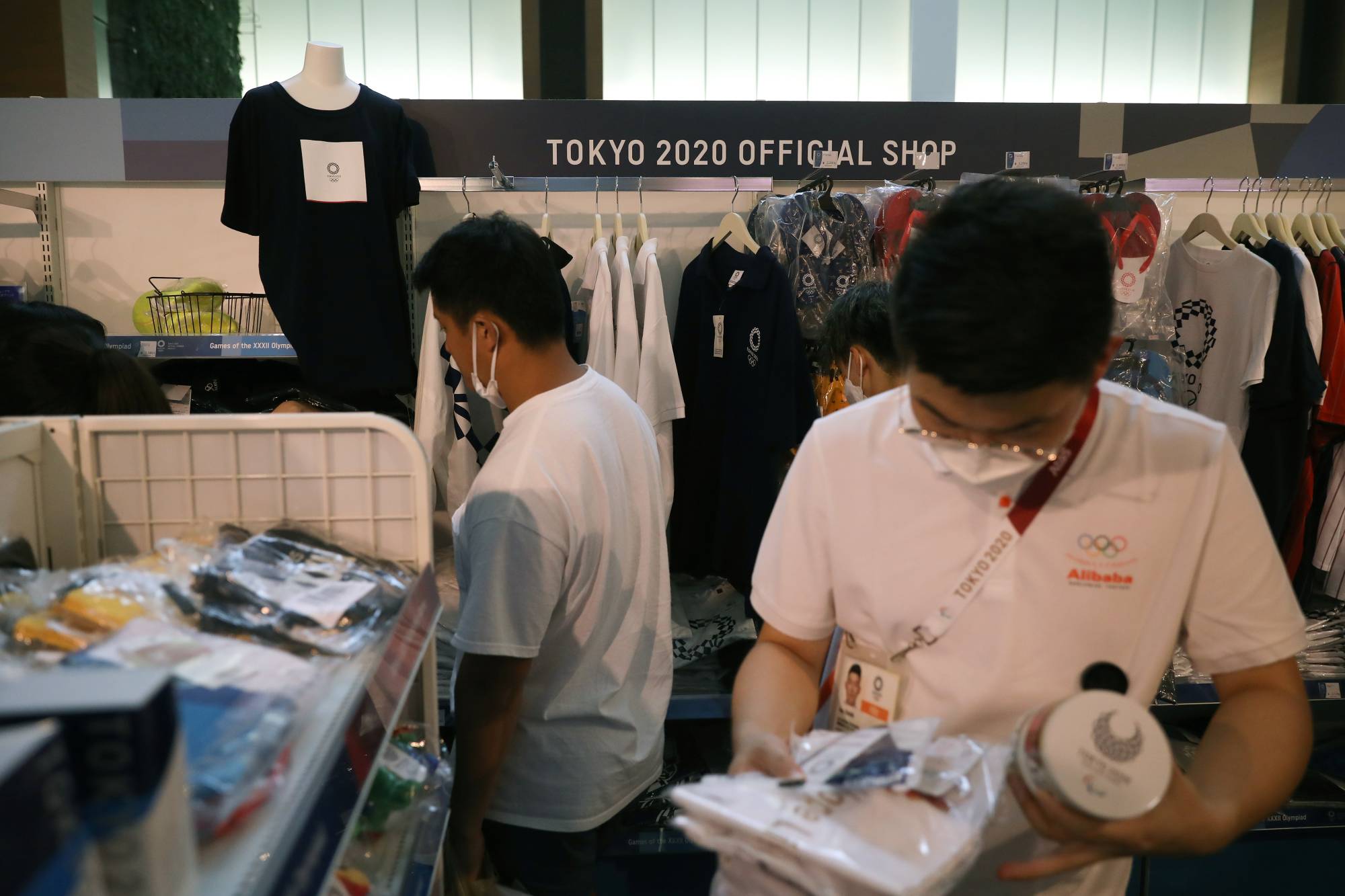 People shop in an official Olympics store in Tokyo on July 30. | REUTERS
