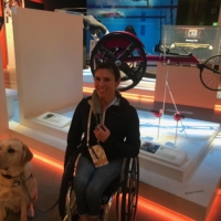 Amanda McGrory poses in front of an exhibit featuring her racing wheelchair at the U.S. Olympic and Paralympic Museum in Colorado Springs, Colorado. | AMANDA MCGRORY