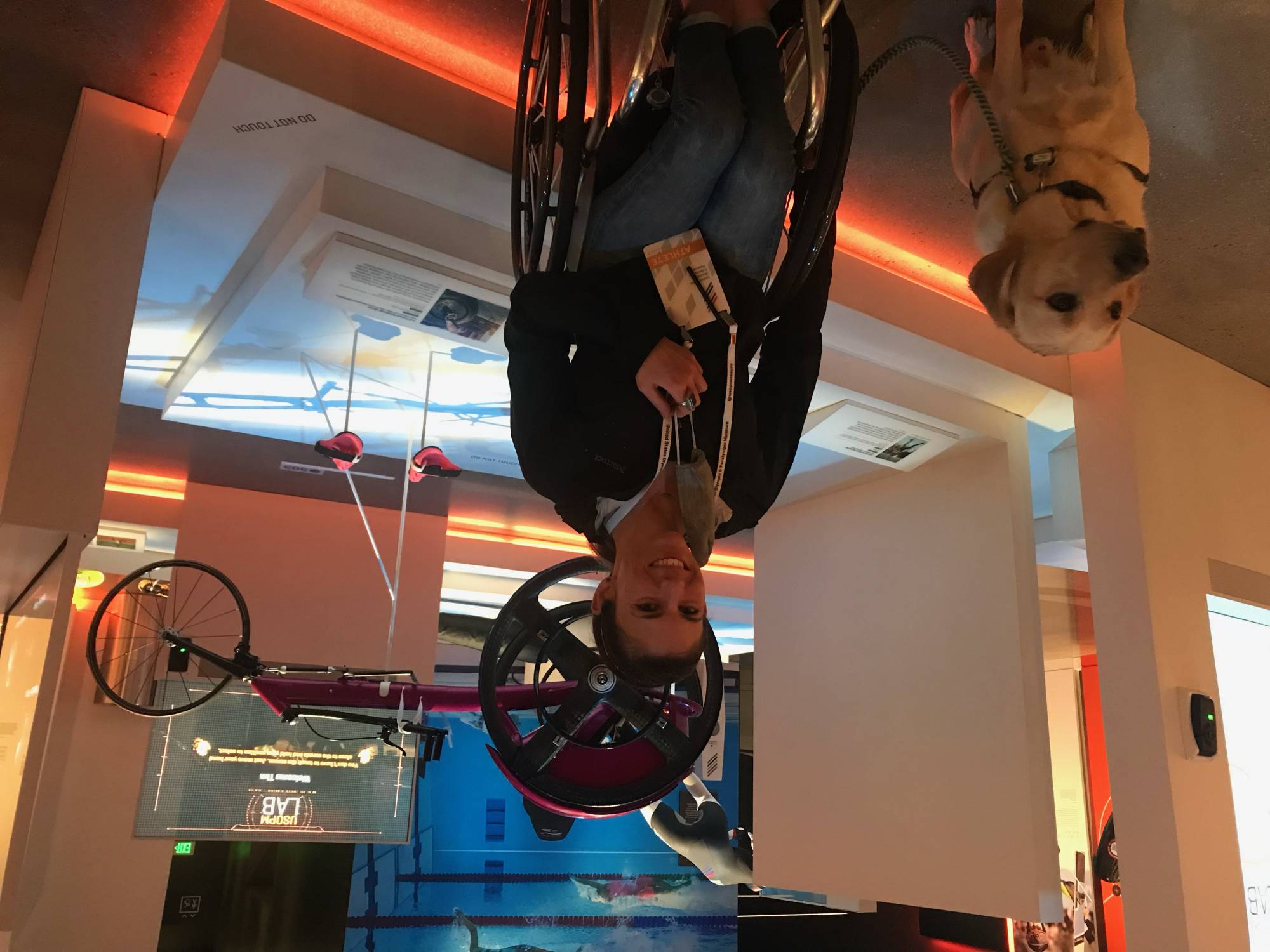Amanda McGrory poses in front of an exhibit featuring her racing wheelchair at the U.S. Olympic and Paralympic Museum in Colorado Springs, Colorado. | Amanda McGrory