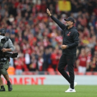 Liverpool manager Jurgen Klopp waves to fans at Anfield after the team\'s 2-0 win over Burnley on Saturday in Liverpool, England. | REUTERS