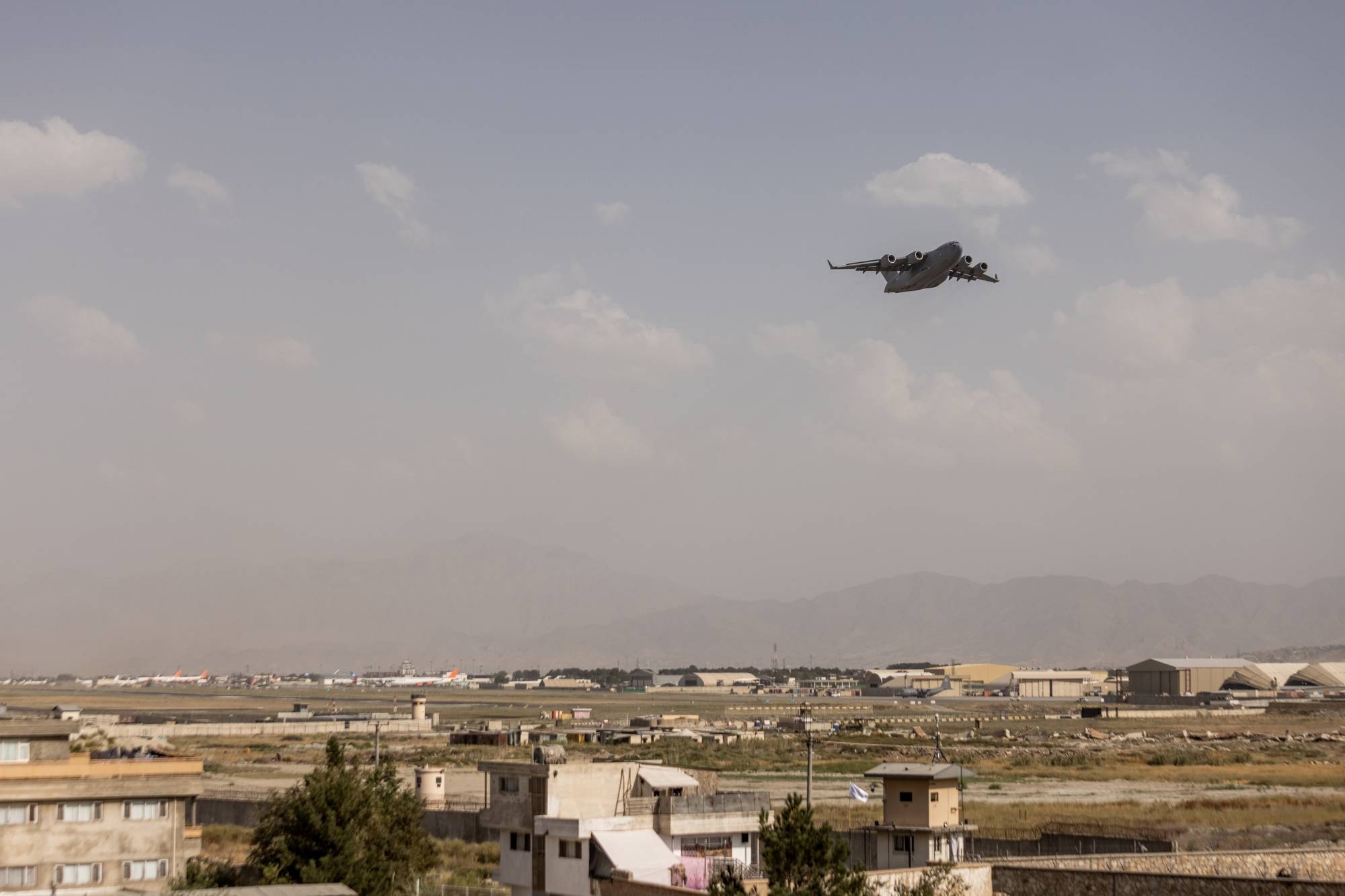 A military cargo plane takes off from the airport in Kabul on Saturday. | Jim Huylebroek / The New York Times