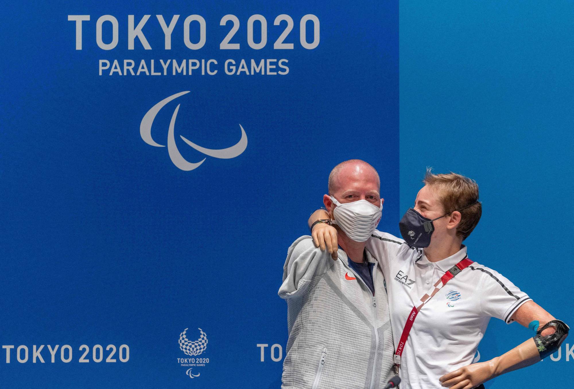 U.S. archer Matt Stutzman and Italian fencer Bebe Vio pose for photos after a news conference in Tokyo on Sunday. | AFP PHOTO / Olympic Information Services