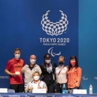 Paralympians Markus Rehm, Matt Stutzman, Amalia Perez, Husnah Kukundawke, Bebe Vio and Shoko Ota pose for photographs during a news conference on Sunday. | AFP-JIJI