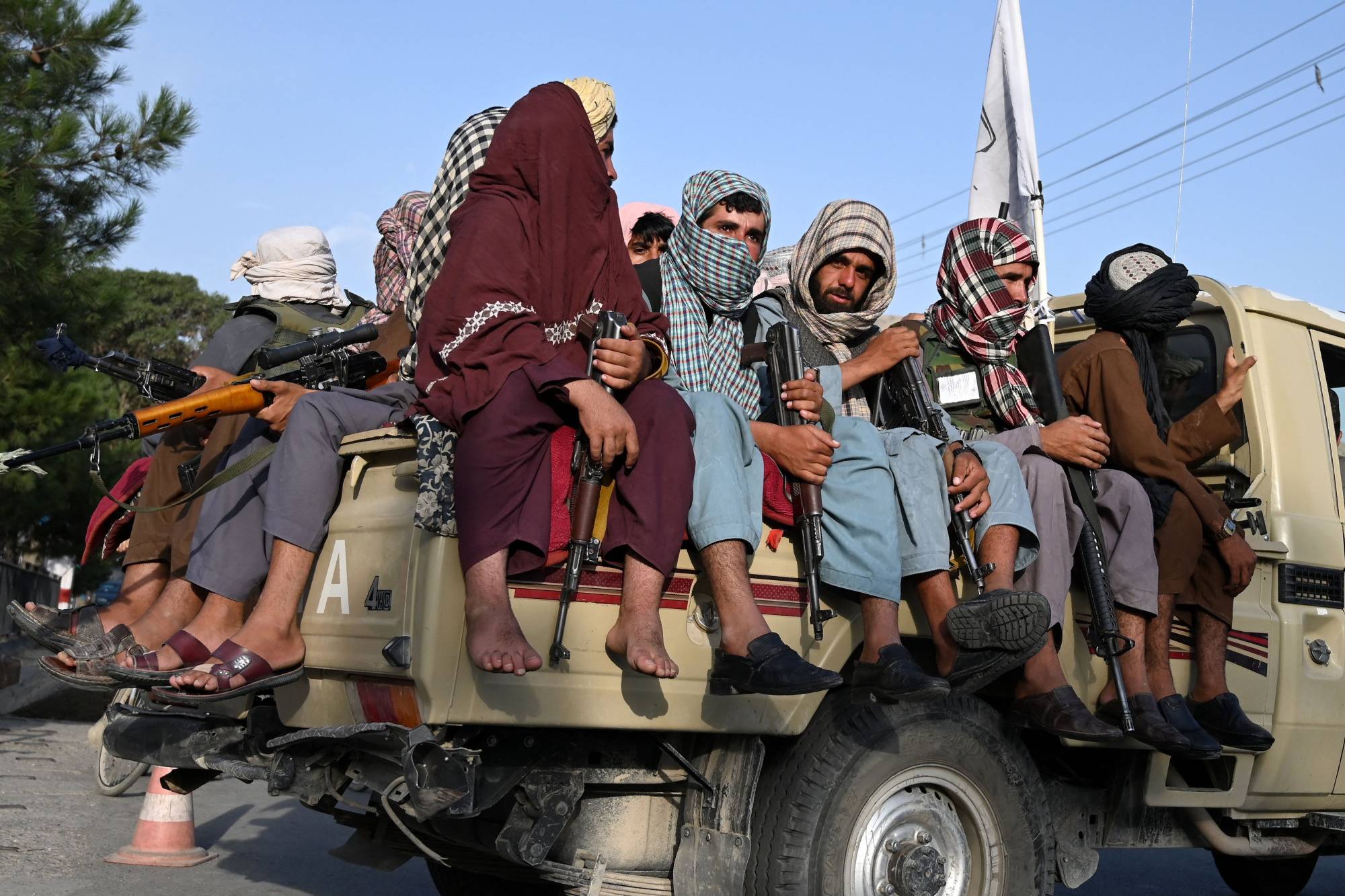 Taliban fighters patrol the streets of Kabul on Monday. | AFP-JIJI
