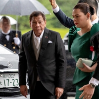 Philippine President Rodrigo Duterte arrives with his daughter, Sara Duterte-Carpio, to attend the Enthronement Ceremony of Emperor Naruhito in Tokyo in October 2019.  | REUTERS 