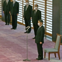 Emperor Naruhito (right) meets with Andrew Parsons (second from left), president of the International Paralympic Committee, at the Imperial Palace in Tokyo on Tuesday, ahead of the opening ceremony of the Tokyo Paralympics later in the day. | POOL / VIA KYODO
