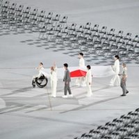 Athletes carry the Japanese national flag at the beginning of the opening ceremony. | DAN ORLOWITZ
