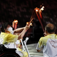 The Paralympic flame is transferred during the opening ceremony. | REUTERS