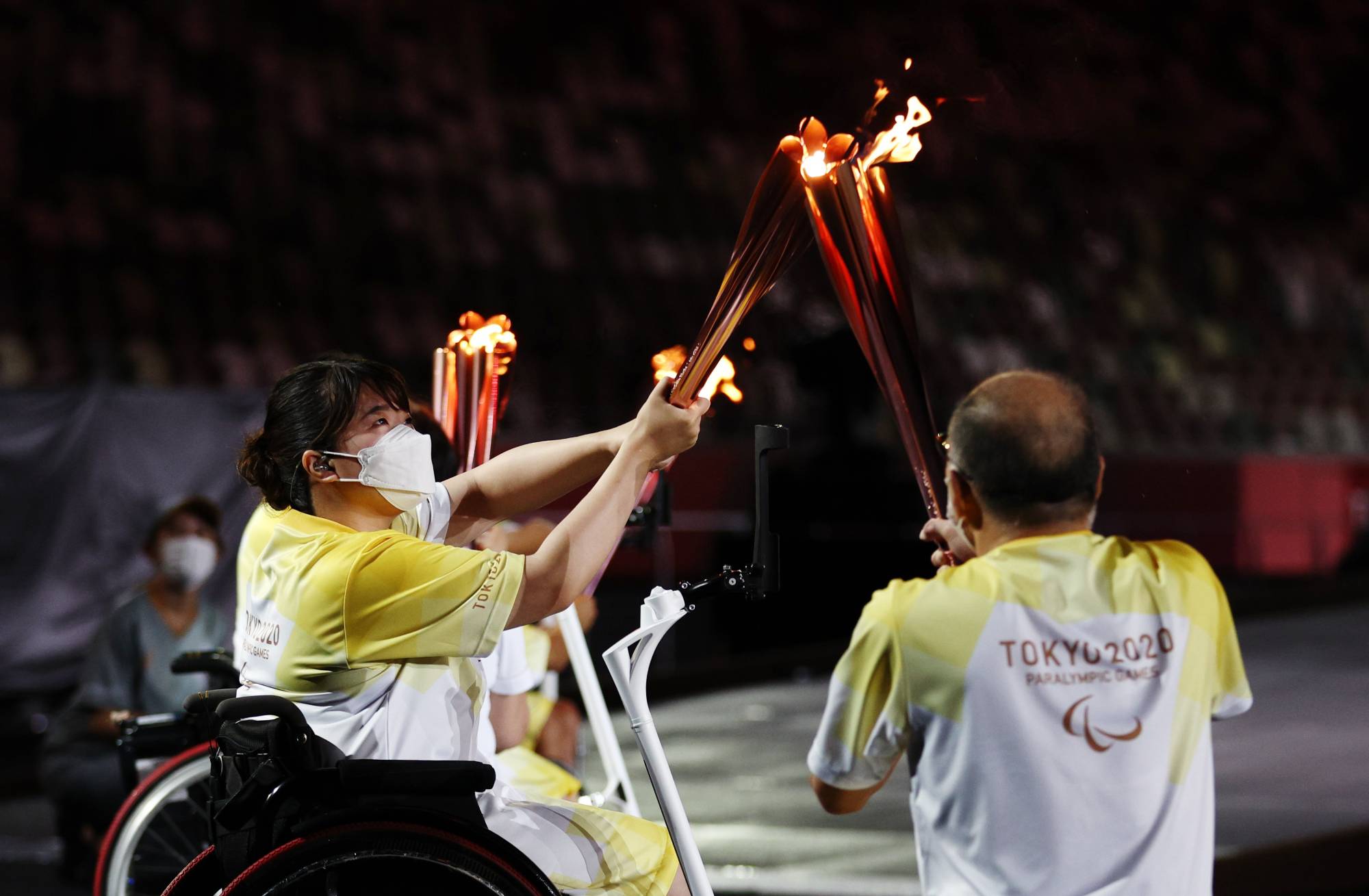 The Paralympic flame is transferred during the opening ceremony. | REUTERS