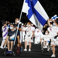 Finland\'s Henry Manni and Pia-Pauliina Reitti lead their contingent during the athletes parade. | REUTERS
