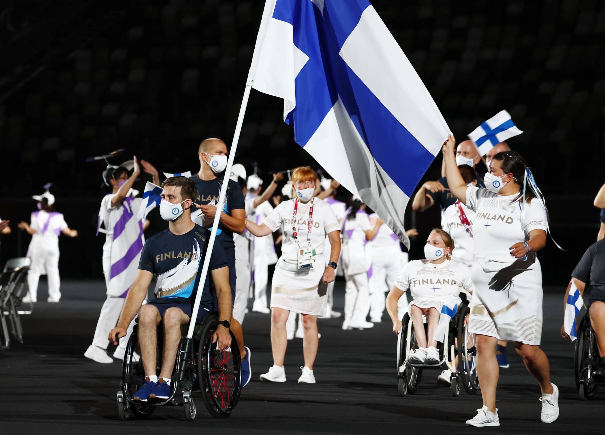 Finland's Henry Manni and Pia-Pauliina Reitti lead their contingent during the athletes parade. | REUTERS