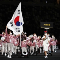 Choi Yejin of the Republic of Korea leads her contingent during the athletes parade. | REUTERS
