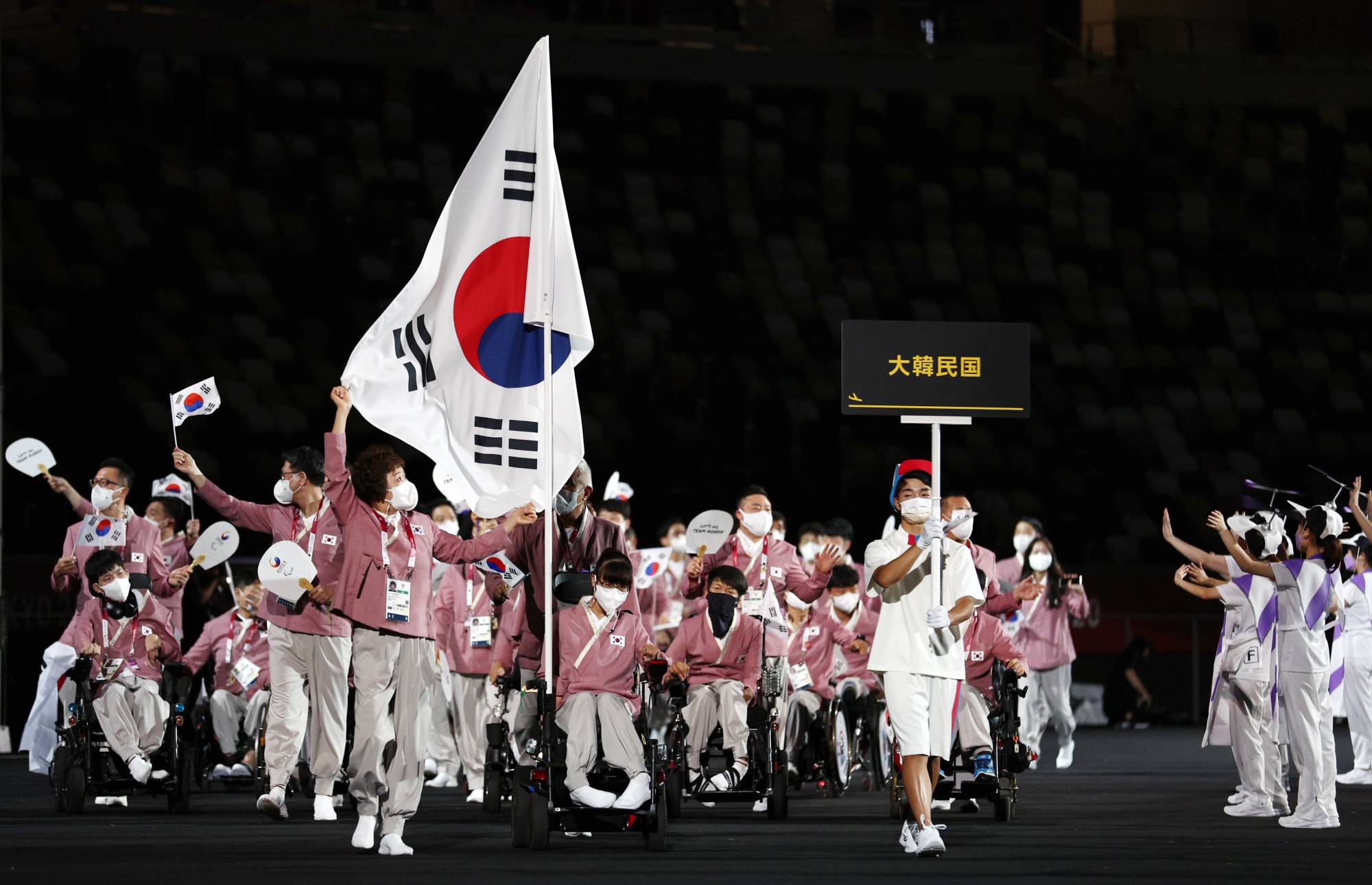 Choi Yejin of the Republic of Korea leads her contingent during the athletes parade. | REUTERS