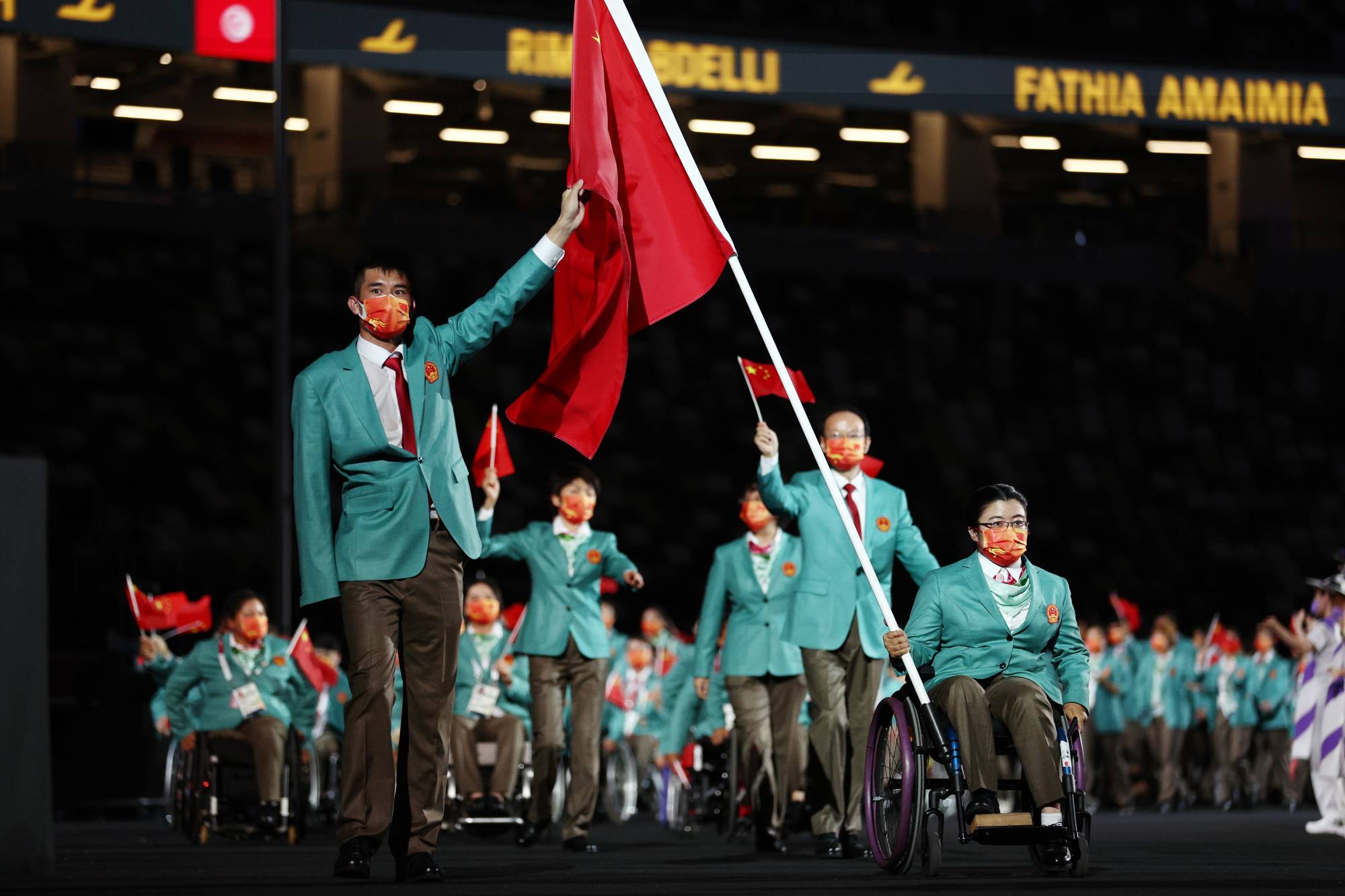 Wang Hao and Zhou Jiamin of China lead their contingent during the athletes parade. | REUTERS