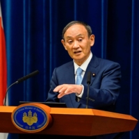 Prime Minister Yoshihide Suga speaks during a news conference announcing the extension of a state of emergency, in Tokyo on Aug. 17. | POOL / VIA REUTERS