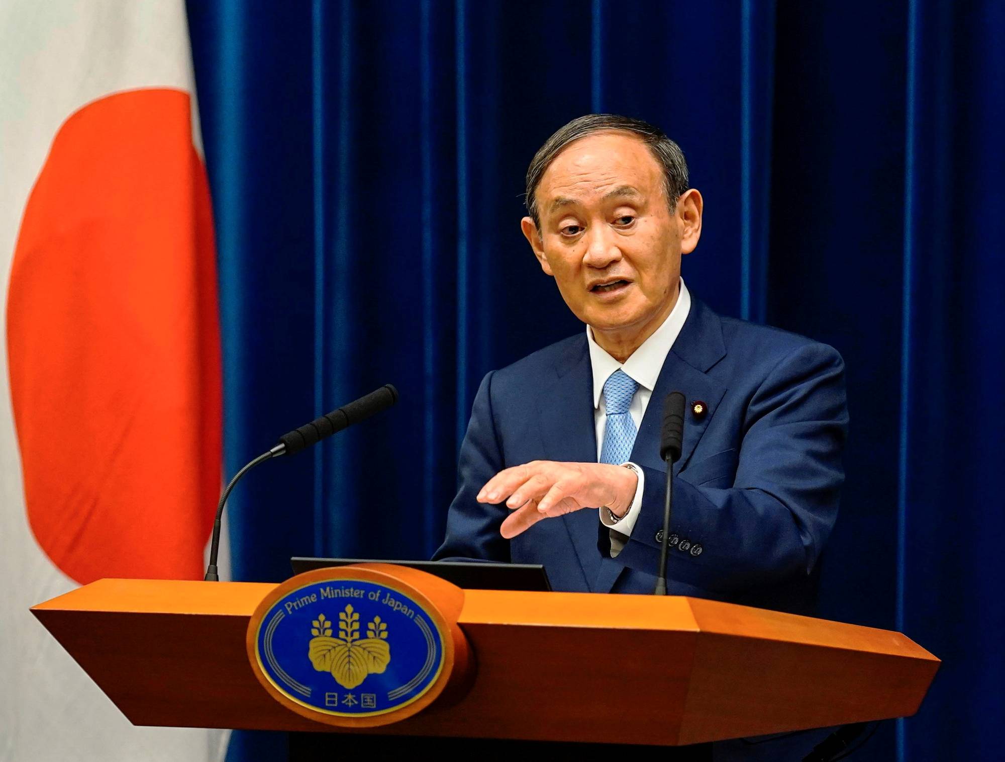 Prime Minister Yoshihide Suga speaks during a news conference announcing the extension of a state of emergency, in Tokyo on Aug. 17. | POOL / VIA REUTERS