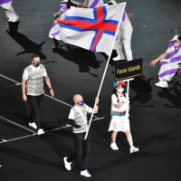 Faroese marathon runner Havard Vatnhamar carries the flag of the Faroe Islands during the opening ceremony of the Tokyo Paralympics on Tuesday at National Stadium. | DAN ORLOWITZ 
