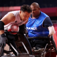 Japan\'s Yukinobu Ike (left) tries to get past France\'s Cedric Nankin during their Paralympic wheelchair rugby match on Wednesday. | REUTERS