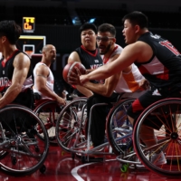 Manuel Lorenzo Diaz of Spain in action against Dong Gil Yang of South Korea during a preliminary round of men\'s wheelchair basketball | REUTERS