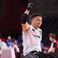 Japan\'s Yukinobu Ike and Kae Kurahashi celebrate winning their wheelchair rugby against France. | REUTERS