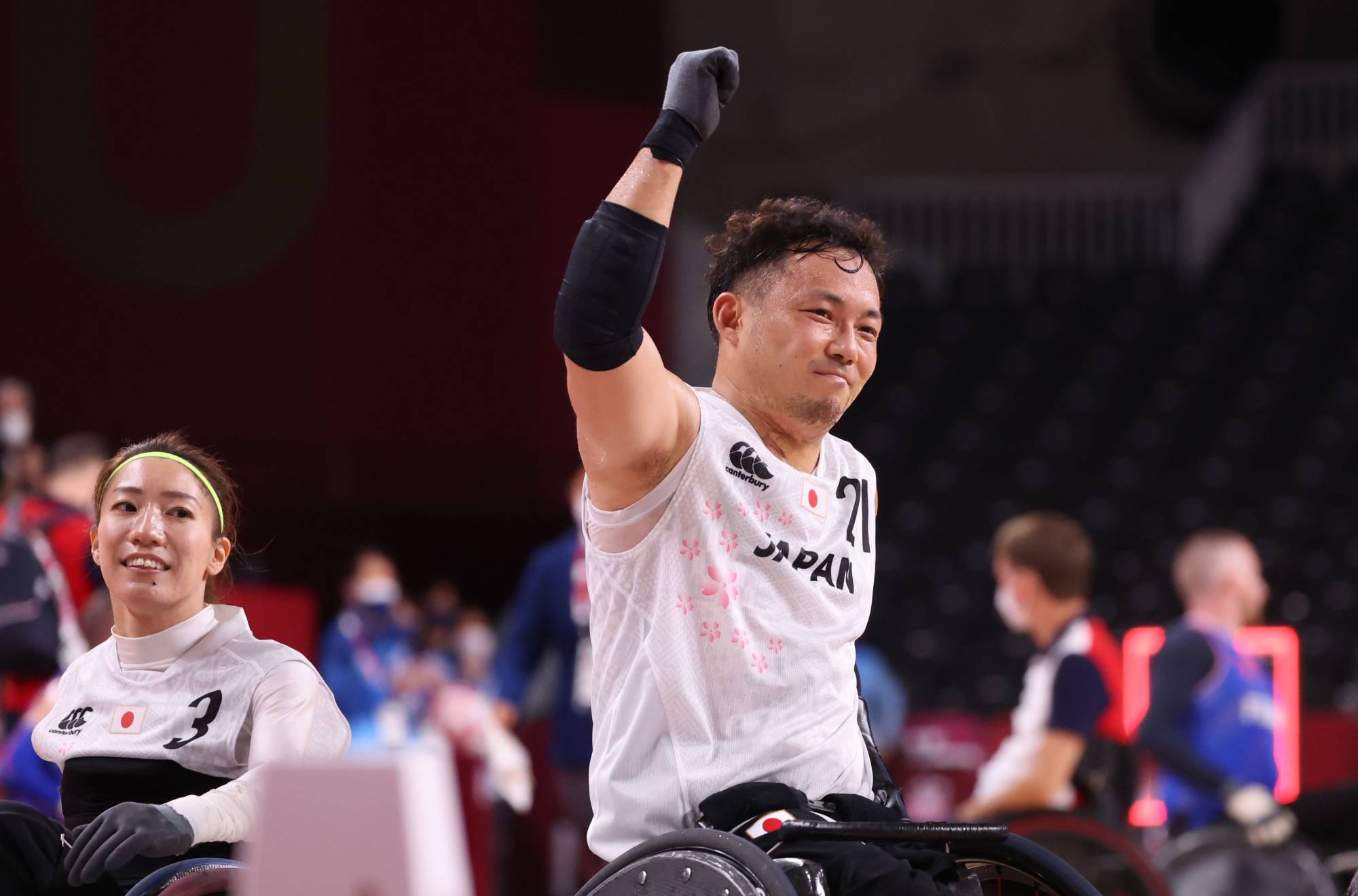 Japan's Yukinobu Ike and Kae Kurahashi celebrate winning their wheelchair rugby against France. | REUTERS