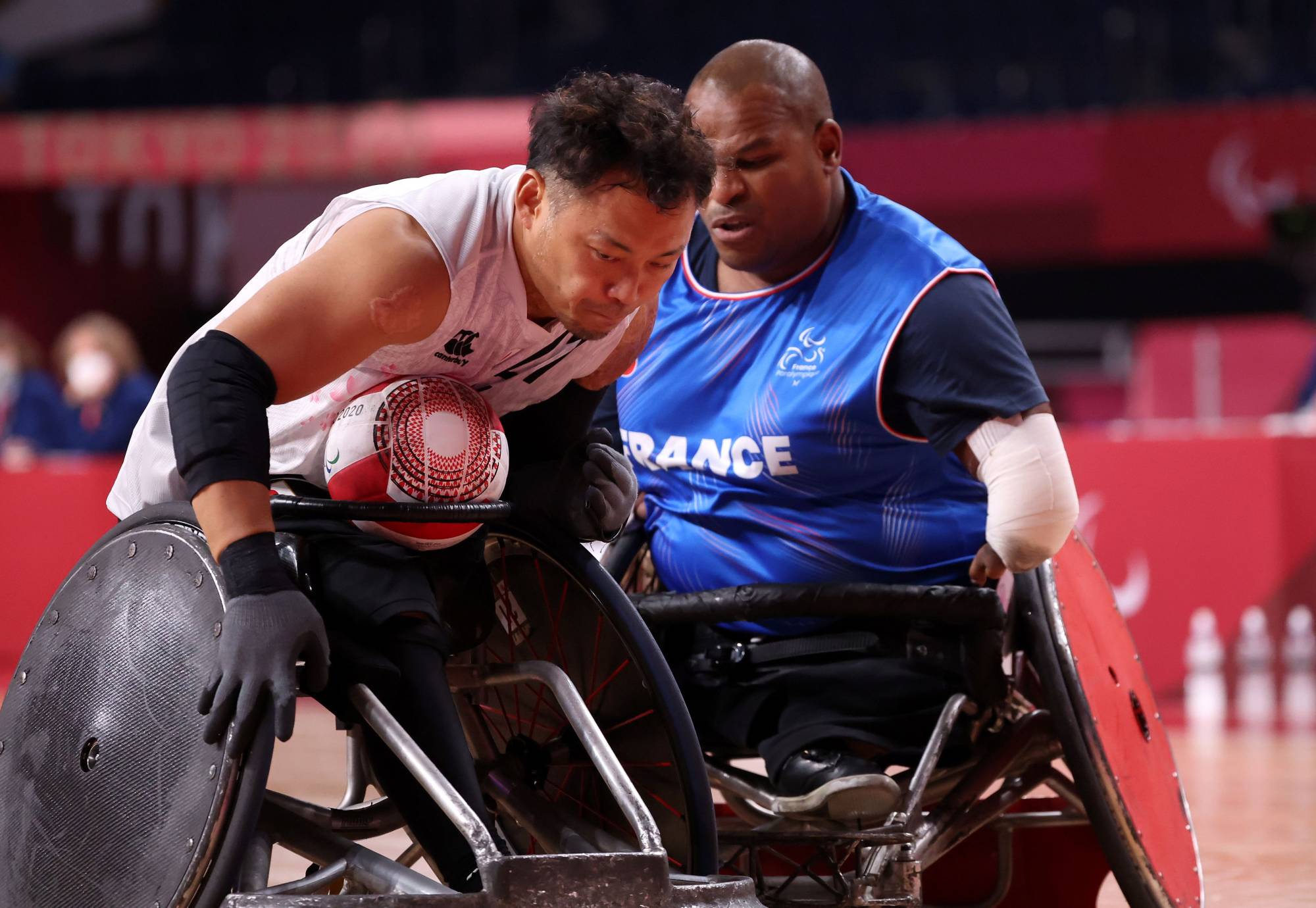 Japan's Yukinobu Ike (left) tries to get past France's Cedric Nankin during their wheelchair rugby match | REUTERS