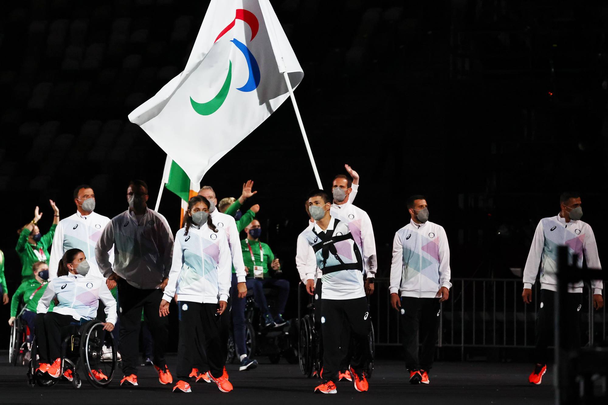 Alia Issa and Abbas Karimi of the Refugee Paralympic Team lead their contingent during the athletes parade at the opening ceremony of the Paralympics on Tuesday. | REUTERS