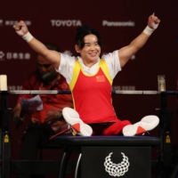 Lingling Guo of China celebrates during the final of the women\'s under-41 kg powerlifting final at Tokyo International Forum on Thursday.  | REUTERS