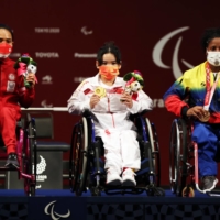 Gold medalist Lingling Guo of China, silver medalist Ni Nengah Widiasih of Indonesia and bronze medalist Clara Sarahy Fuentes Monasterio of Venezuela celebrate after the women\'s under-41 kg final at Tokyo International Forum.  | REUTERS