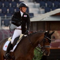 Japan\'s Mitsuhide Miyaji riding Charmander competes in the equestrian dressage individual test grade II  | AFP-JIJI