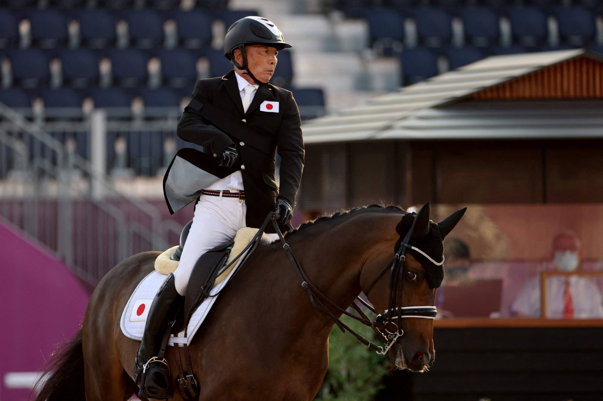 Japan's Mitsuhide Miyaji riding Charmander competes in the equestrian dressage individual test grade II | AFP-JIJI