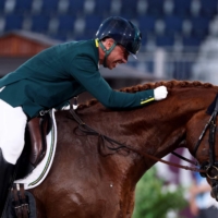 Brazil\'s Rodolpho Riskalla riding hugs his horse, Don Henrico, after competing in the equestrian dressage individual test grade IV | AFP-JIJI