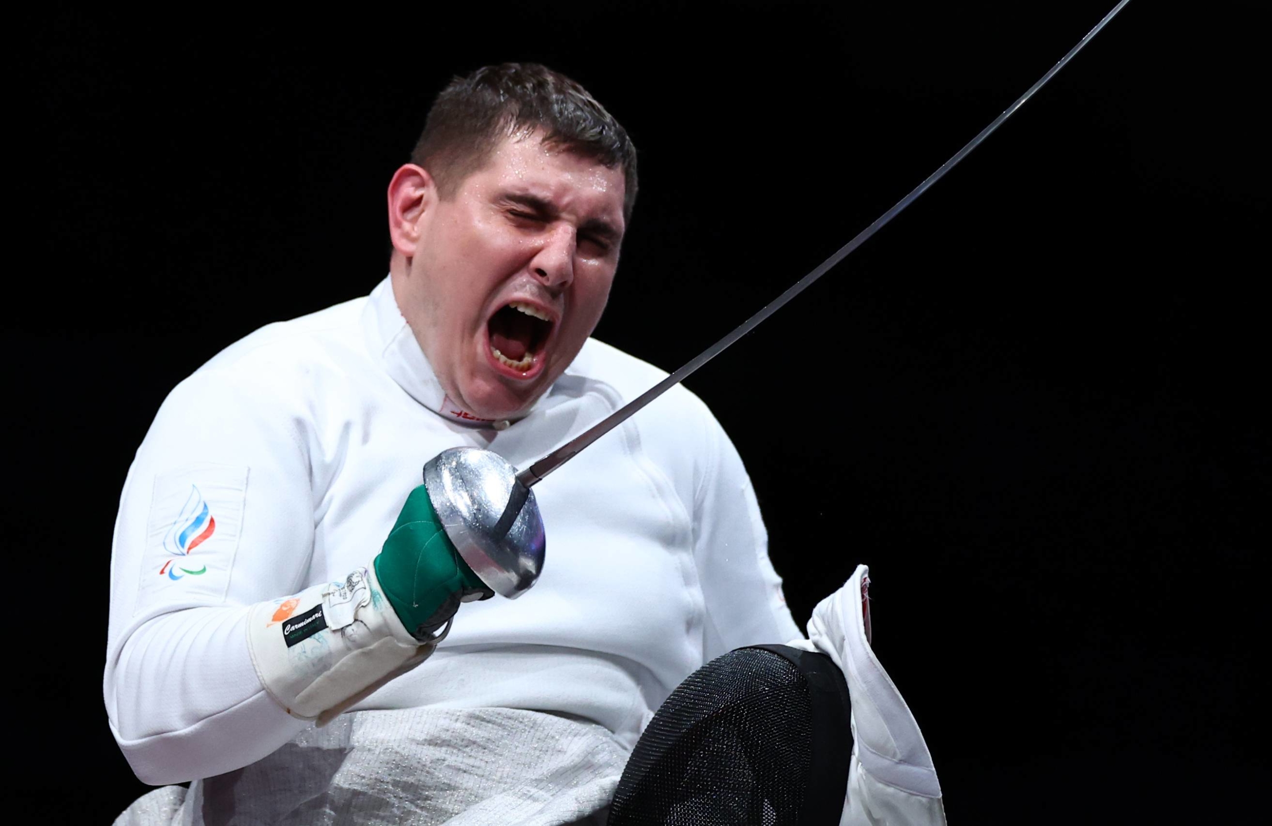 Russian Paralympic Committee's Alexander Kuzyukov reacts after winning against Brazil's Jovane Guissone in men's wheelchair fencing epee individual | REUTERS