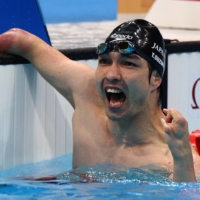 Takayuki Suzuki of Japan celebrates after winning gold in the men\'s 100-meter freestyle S4 class. | REUTERS