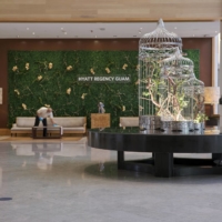 A worker cleans furniture in the lobby of the Hyatt Regency Guam in Tmon, Guam, on Aug. 21. The hotel has let go about 100 full- and part-time employees.  | ANTHONY HENRI OFTANA / THE NEW YORK TIMES