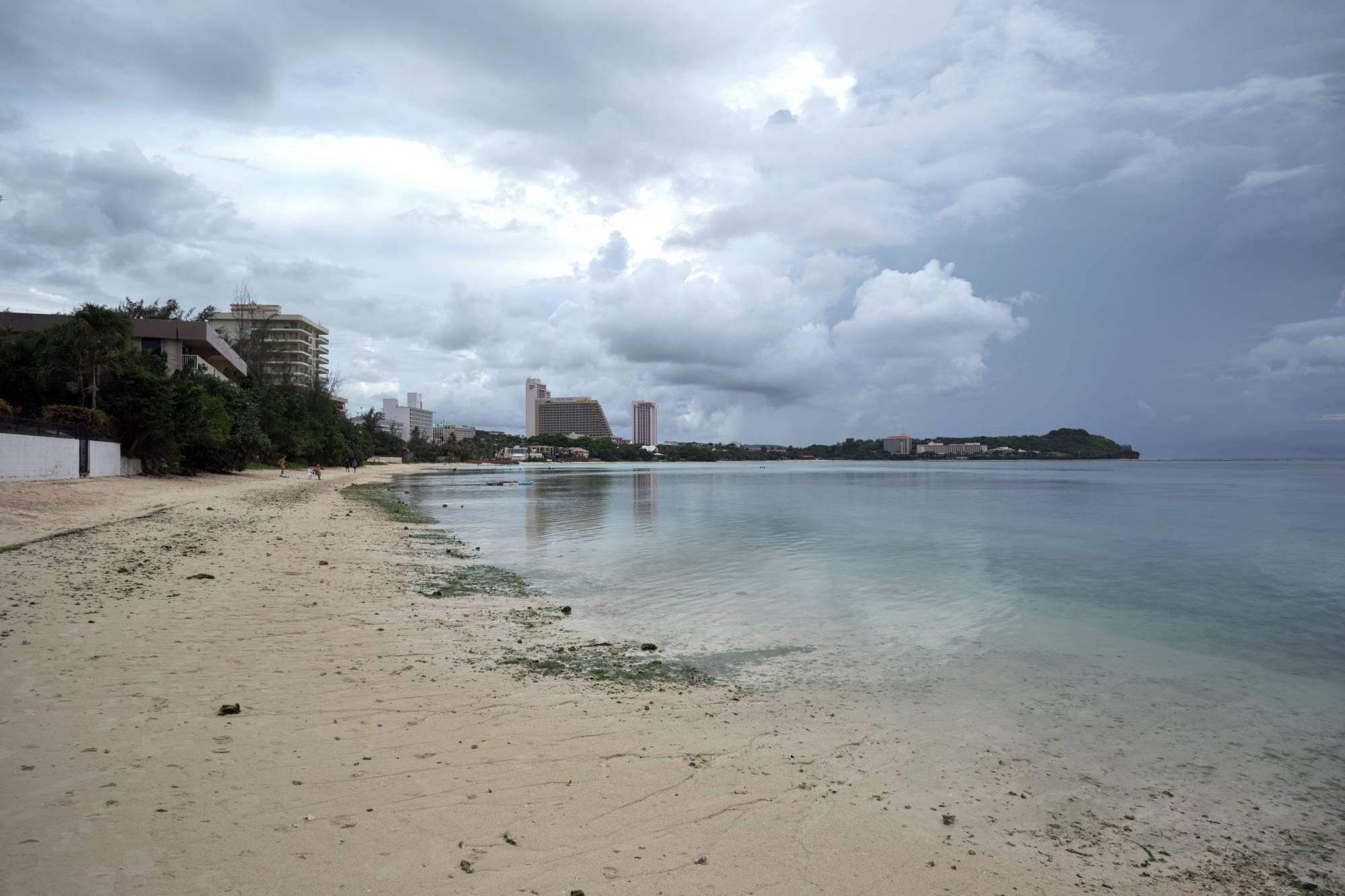 A mostly empty beach at Tumon Bay, Guam, on Aug. 21. Guam once welcomed 1.7 million visitors a year. That number has fallen to a tiny trickle. | Anthony Henri Oftana / The New York Times