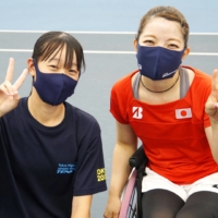 Airi Onuma (left), a volunteer ball girl at the Tokyo Paralympics, alongside wheelchair tennis player Manami Tanaka | HIROKI NAKAJIMA / VIA KYODO 