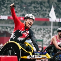 Tomoki Sato reacts after winning the men\'s T52 400-meter final during he Tokyo Paralympics at the National Stadium on Friday. | KYODO