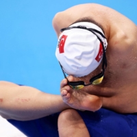 Turkey\'s Bytullah Eroglu removes his goggles after competing in a heat of the men\'s 50-meter butterfly swimming (S5 category). | AFP-JIJI