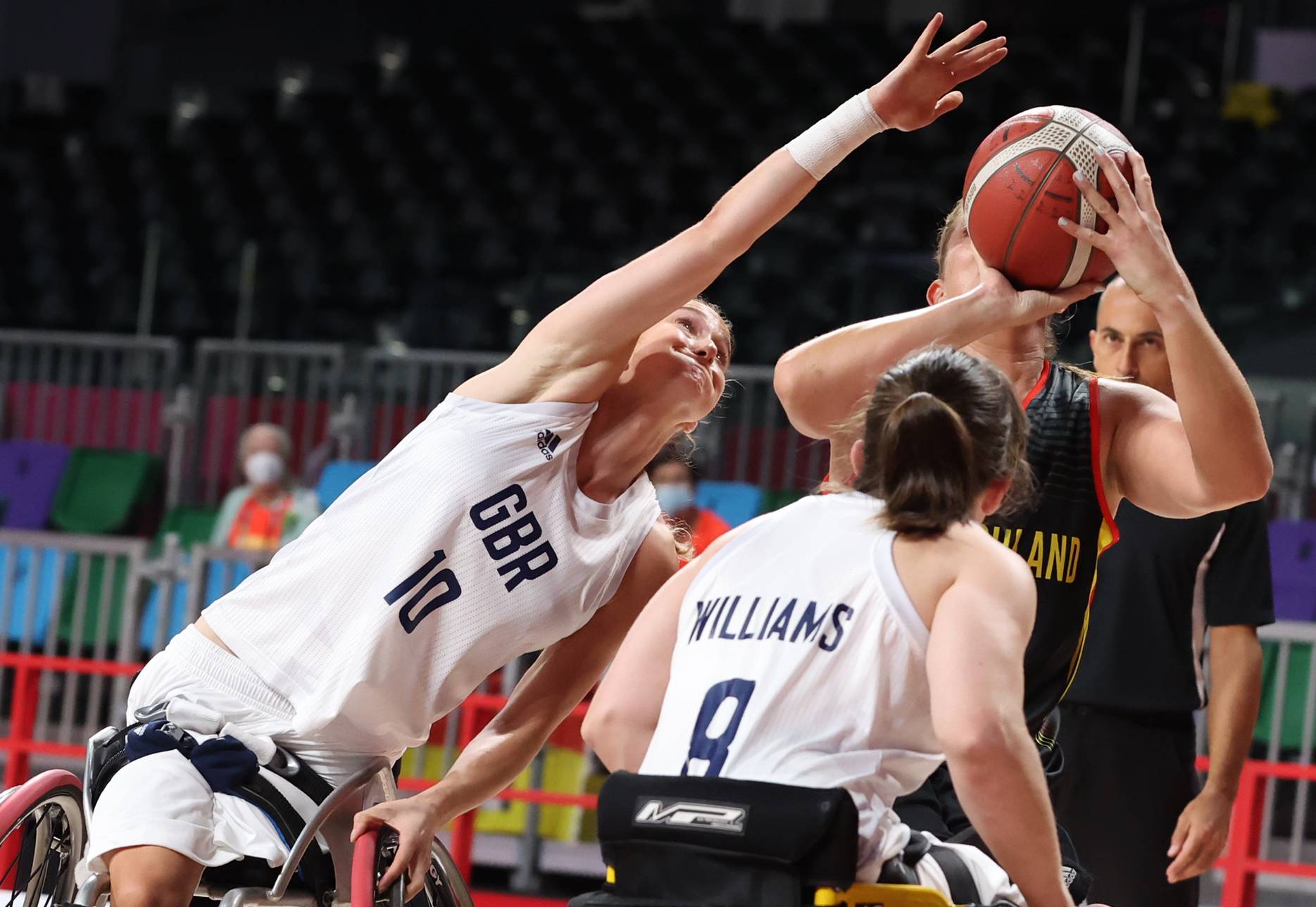 Katharina Lang of Germany in action against Amy Conroy and Laurie Williams of Britain during a preliminary round of wheelchair basketball. | REUTERS