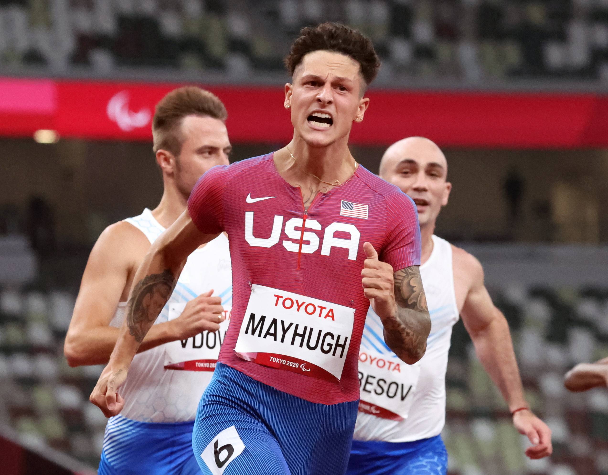 Nick Mayhugh of the United States reacts after winning gold and setting a new world record in the men's T37 100 meters. | REUTERS