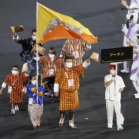 Bhutan\'s Paralympic delegation marches in the Parade of Nations during the opening ceremony at National Stadium on Tuesday.  | KYODO 