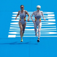 Spain\'s Susana Rodriguez and her guide Sara Loehr approach the finish line to take the gold medal in the women\'s PTVI Paralympic triathlon | OIS