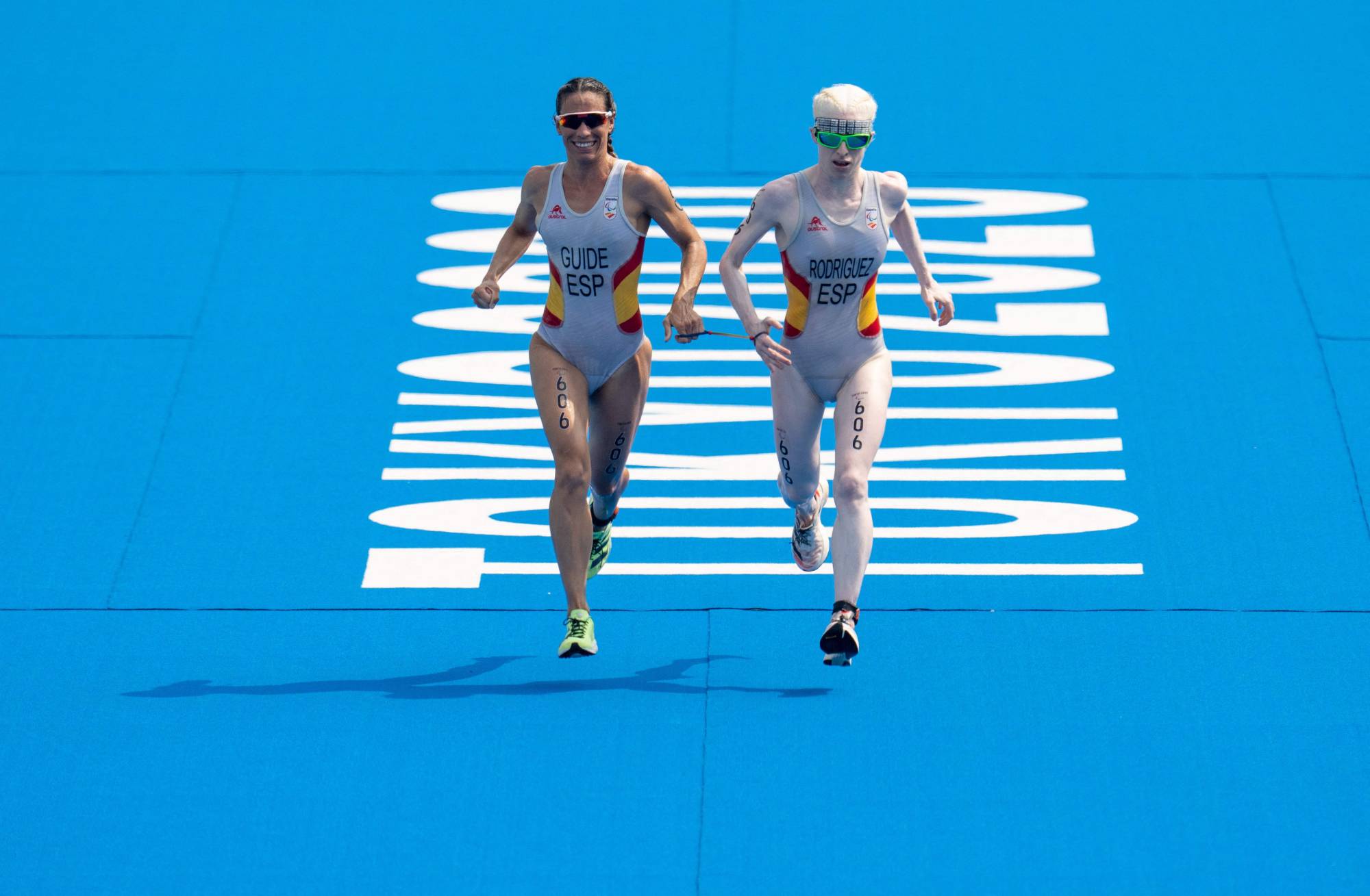 Spain's Susana Rodriguez and her guide Sara Loehr approach the finish line to take the gold medal in the women's PTVI Paralympic triathlon | OIS