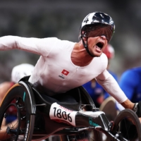 Switzerland\'s Marcel Hug of  reacts after winning gold in the men\'s T54 500 meters. | REUTERS
