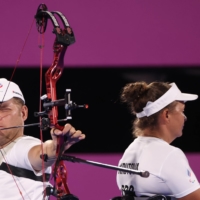 Russian Paralympic Committee\'s Aleksei Leonov and Elena Krutova compete during the mixed team W1 archery quarterfinals against China. | REUTERS