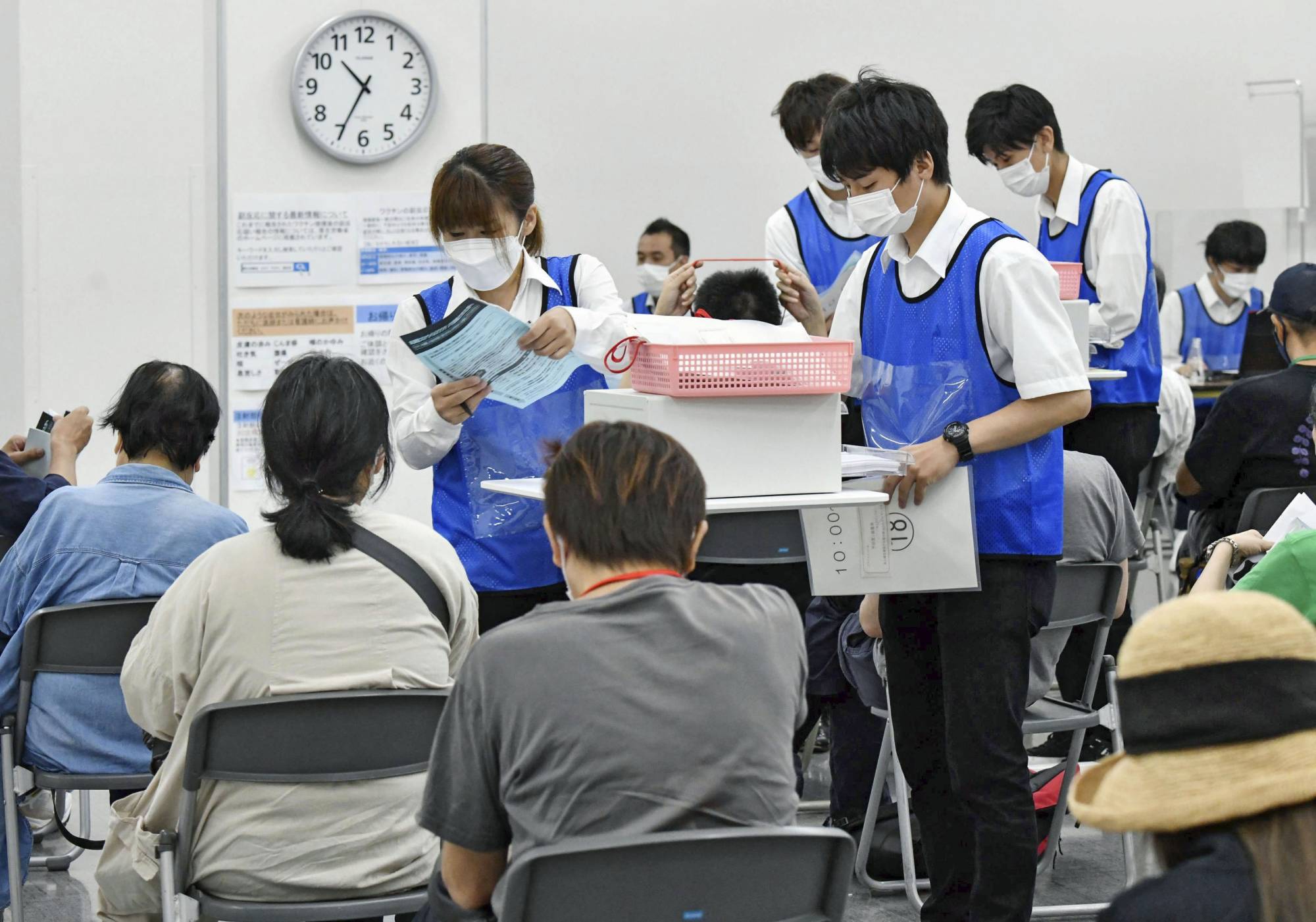 People who received their first dose of AstraZeneca PLC's vaccine at a mass inoculation site in Osaka last week | POOL / VIA KYODO